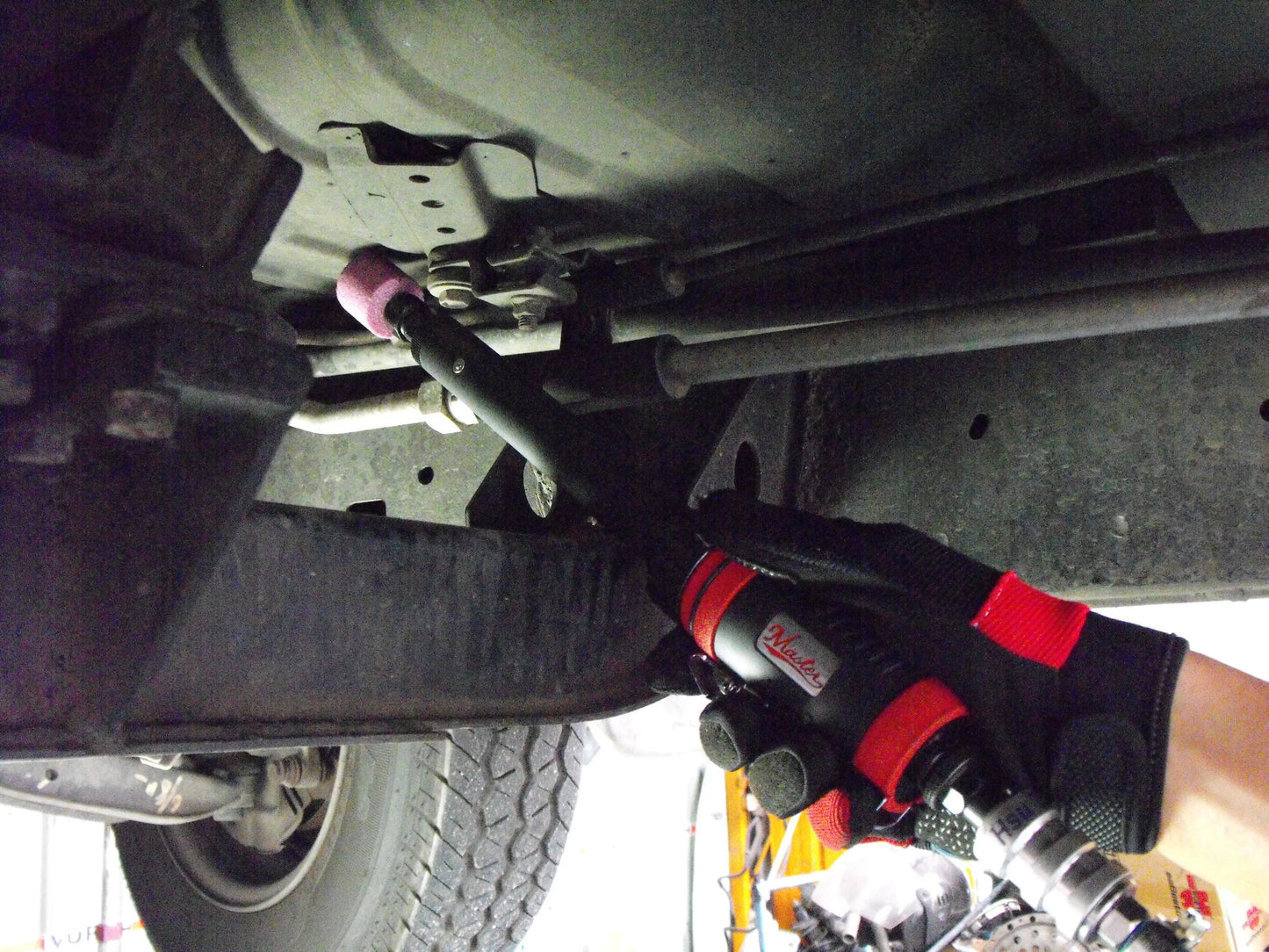 a person in a red and black uniform working on a vehicle